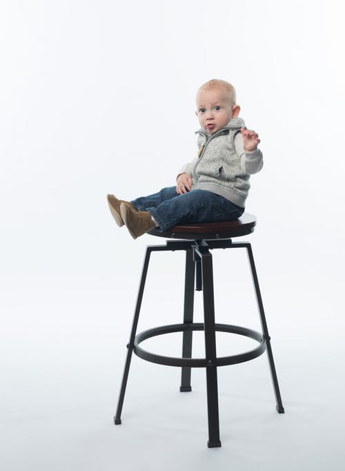 little guy on stool